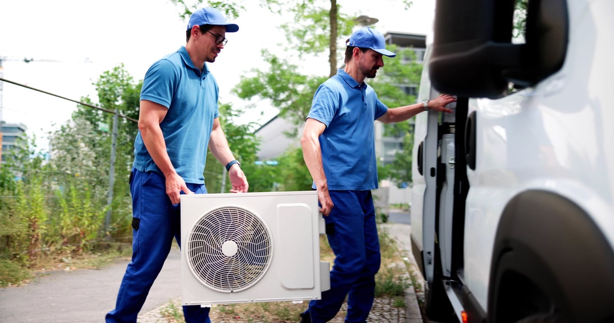 Certified commercial HVAC technician checking air conditioner installation gear
